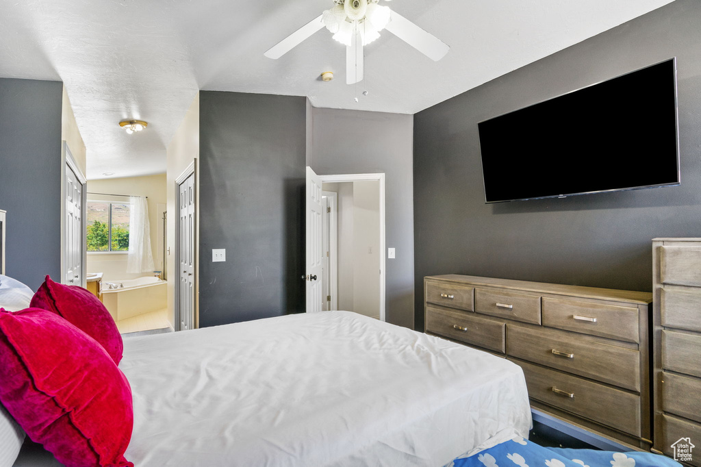 Bedroom featuring ensuite bathroom and a ceiling fan