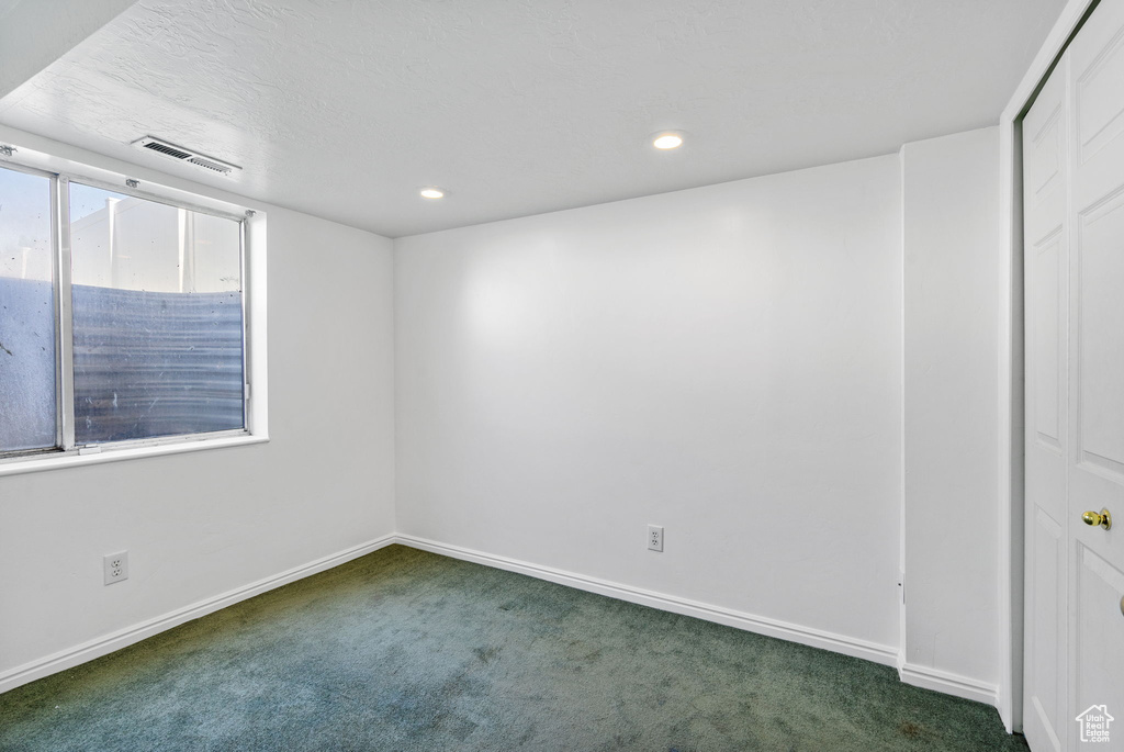 Empty room with carpet, recessed lighting, and baseboards