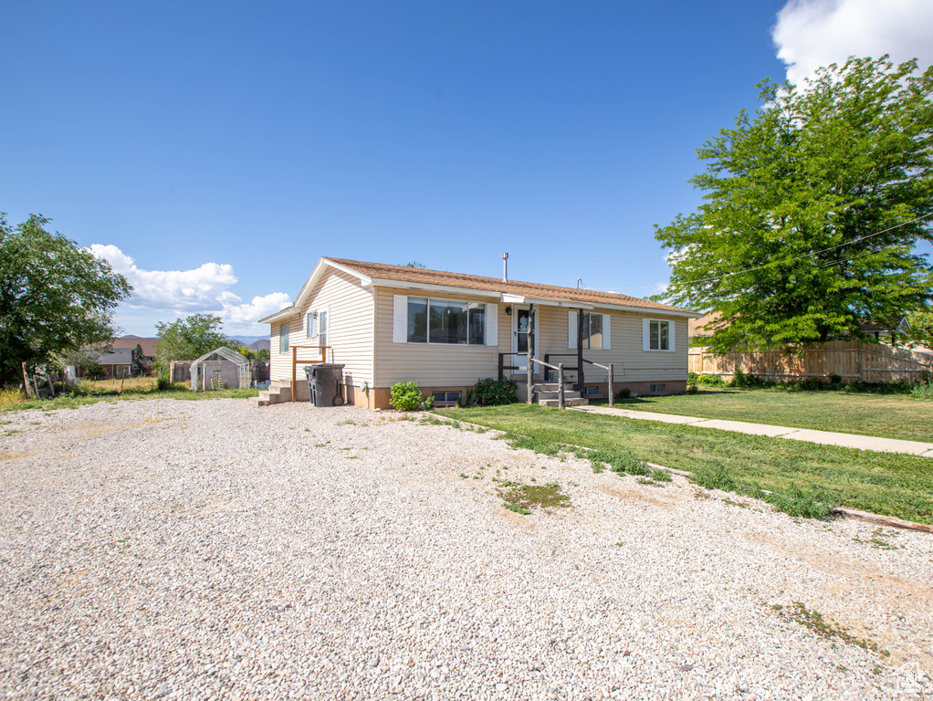 View of front of home featuring gravel driveway
