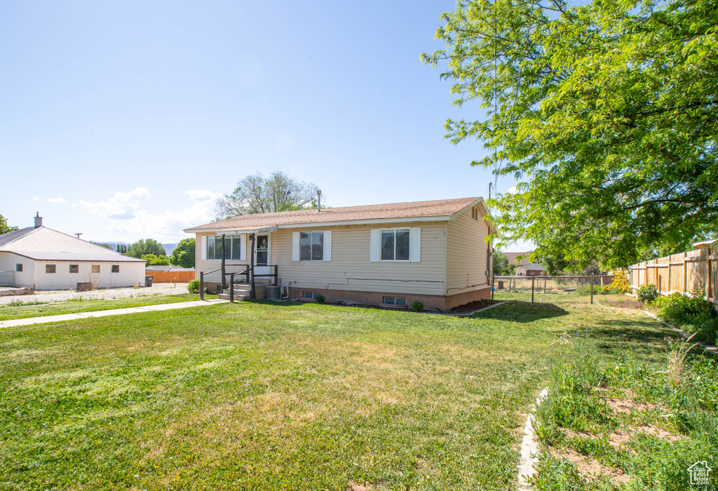 Back of house with central AC unit