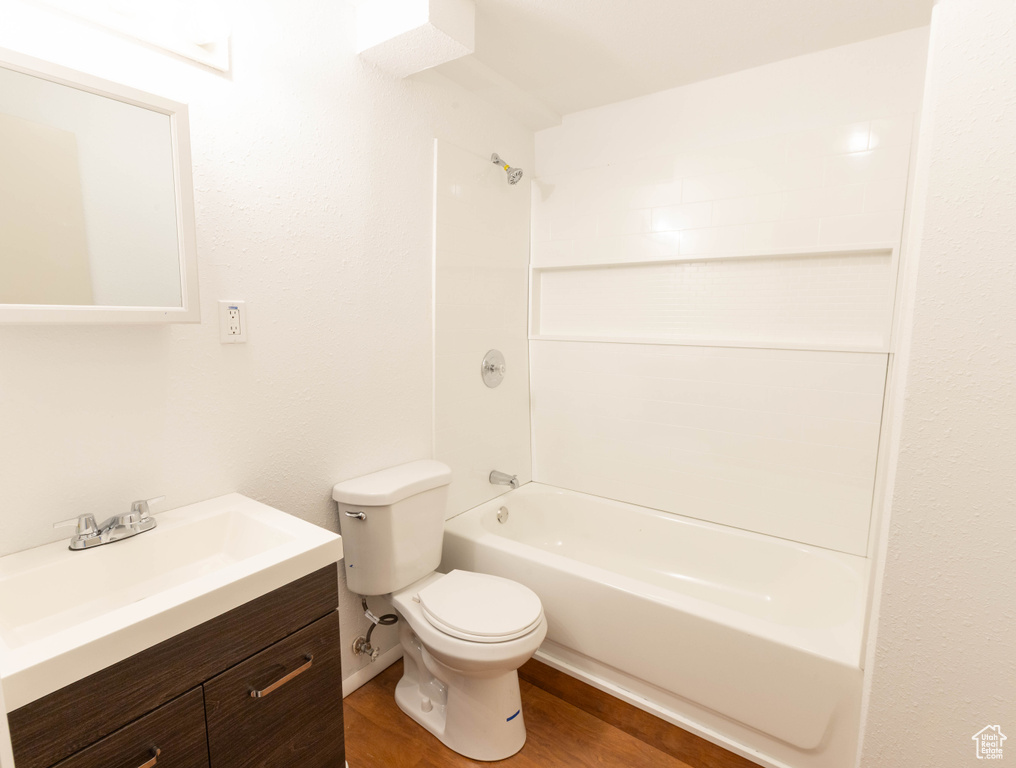Bathroom with toilet, vanity, and shower / washtub combination