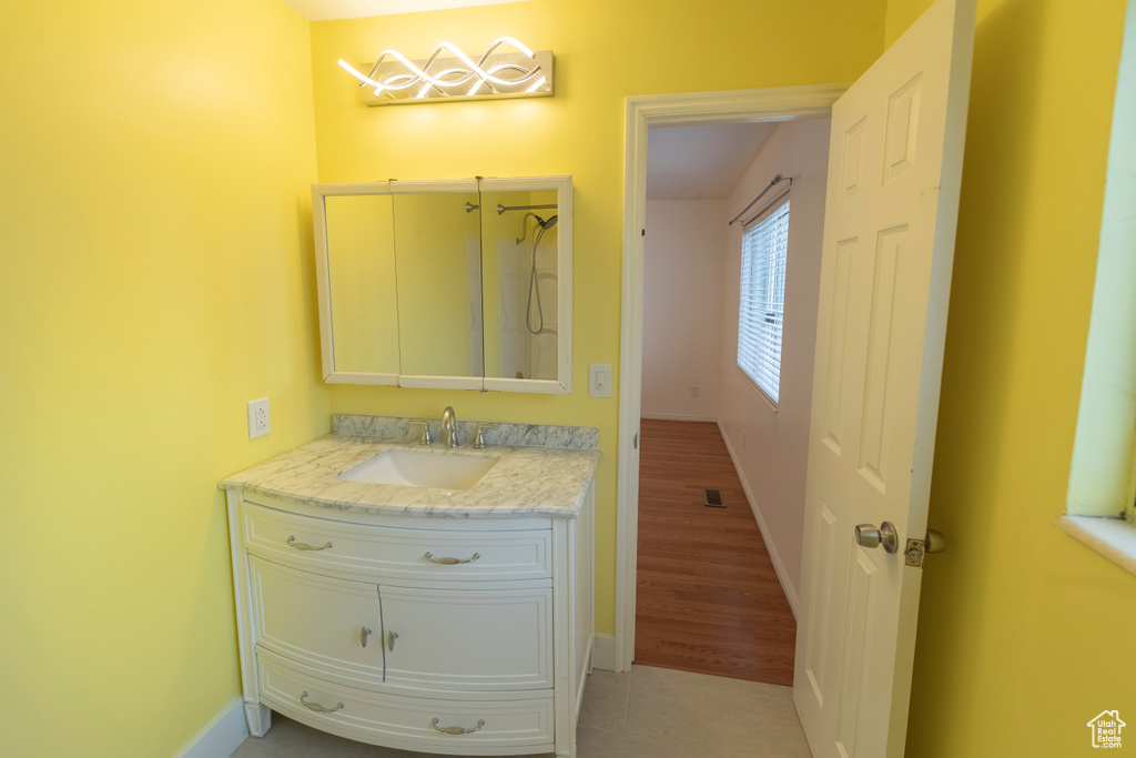 Bathroom with vanity and baseboards