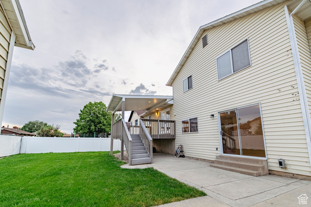 Rear view of property featuring entry steps, a patio area, stairway, and a deck