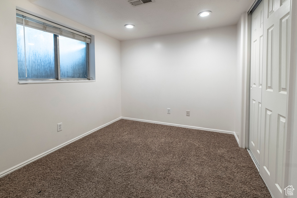 Empty room with carpet, baseboards, and recessed lighting