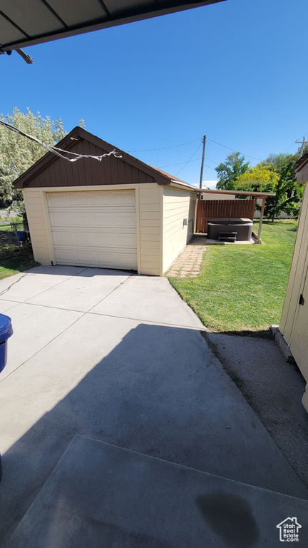 Detached garage with concrete driveway