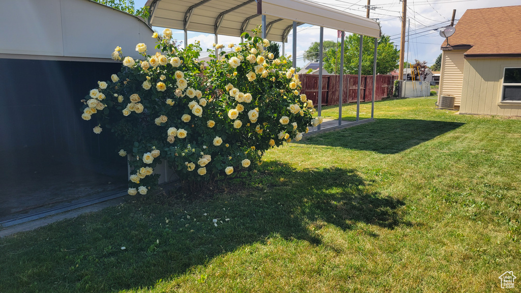 View of yard featuring a carport and cooling unit
