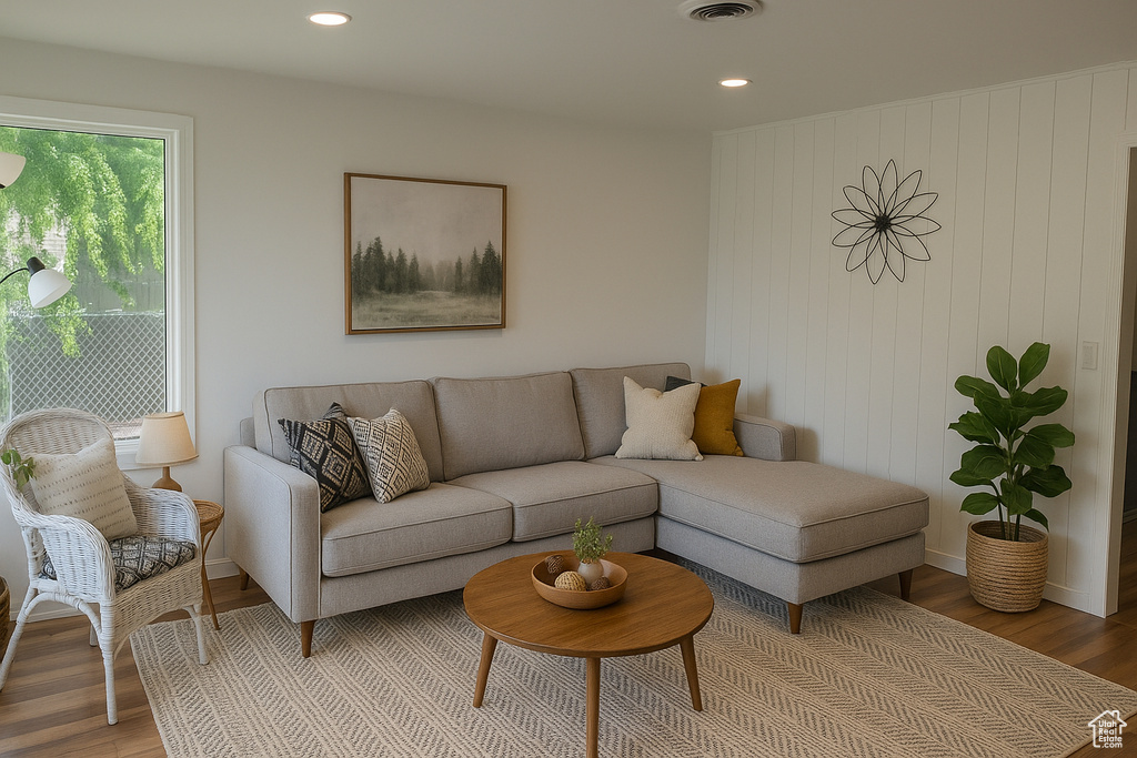 Living room with light wood-style flooring and recessed lighting