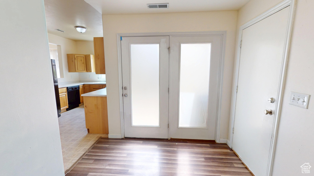 Entryway with light wood finished floors