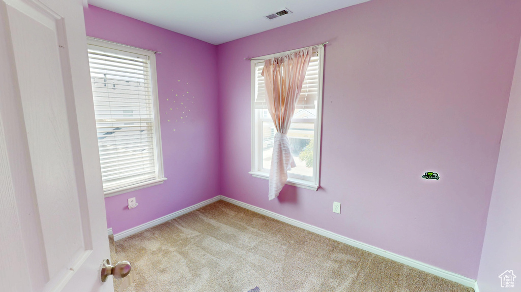 Unfurnished room featuring carpet floors and baseboards
