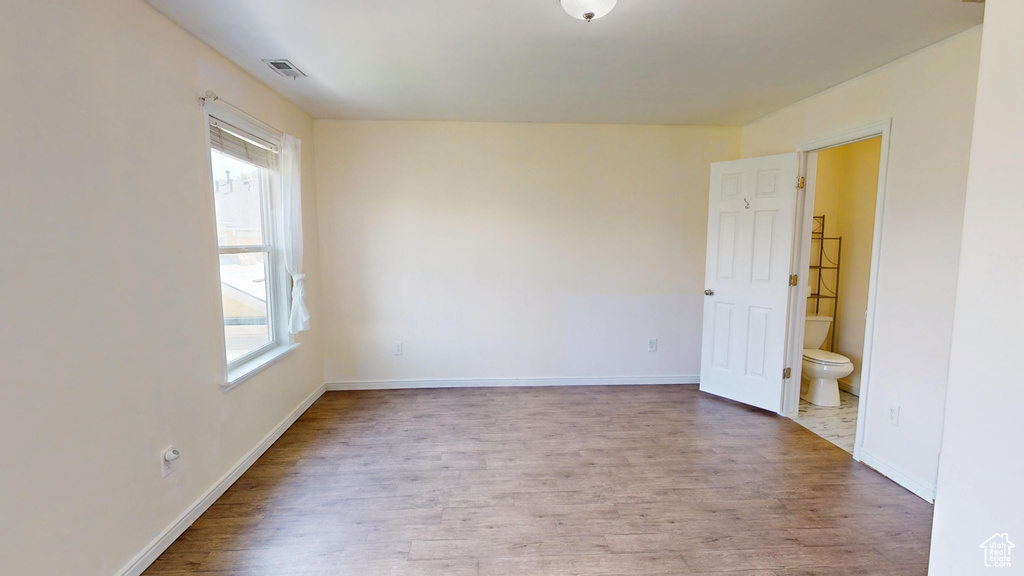 Empty room with wood finished floors and baseboards