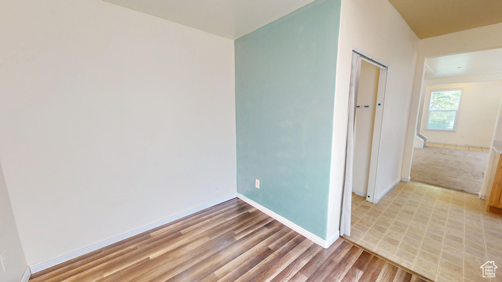 Unfurnished bedroom with baseboards, light wood-type flooring, and a closet