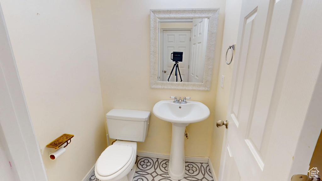 Bathroom featuring toilet and baseboards