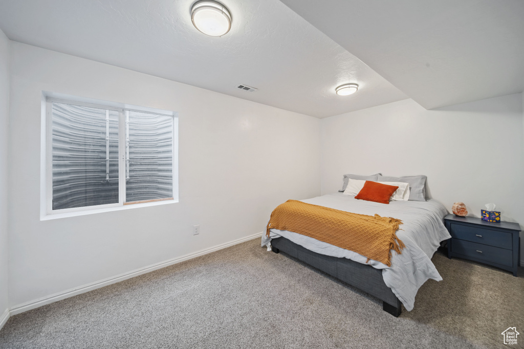 Carpeted bedroom with baseboards