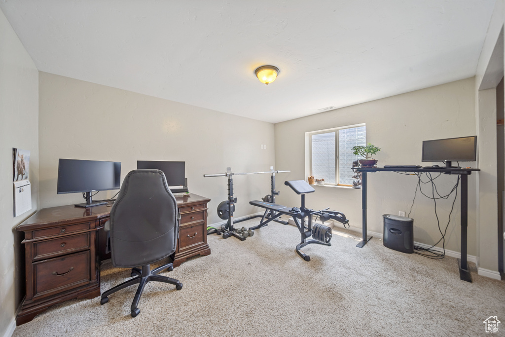 Carpeted office featuring baseboards
