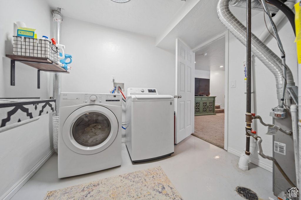 Laundry room featuring separate washer and dryer and baseboards