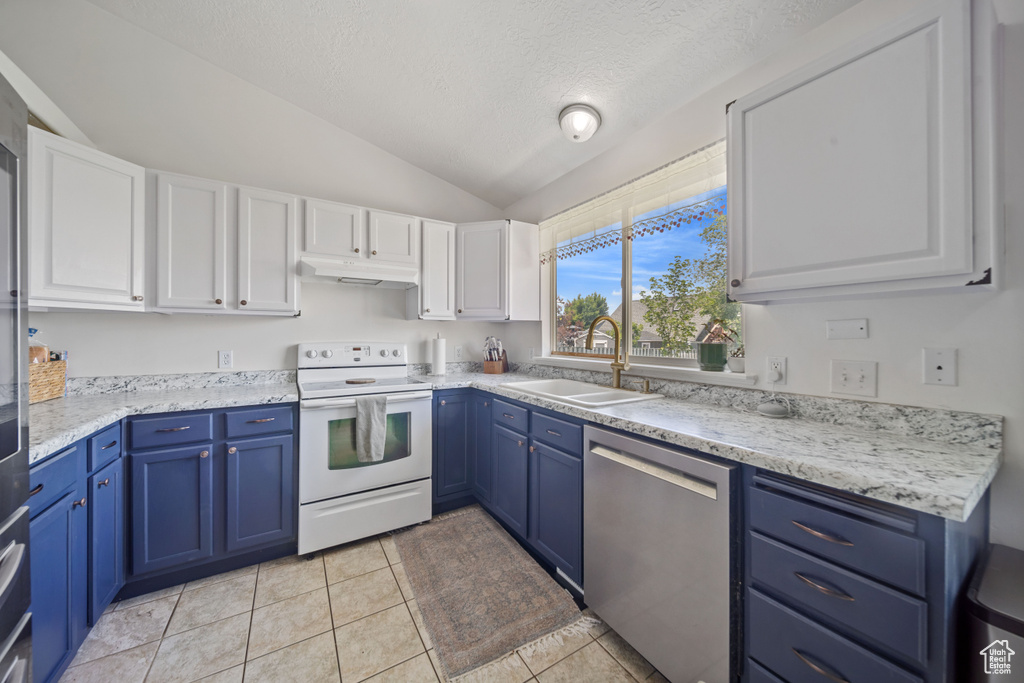 Kitchen with electric range, stainless steel dishwasher, blue cabinetry, a sink, and vaulted ceiling