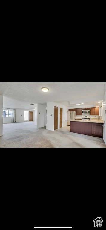 Garage featuring freestanding refrigerator