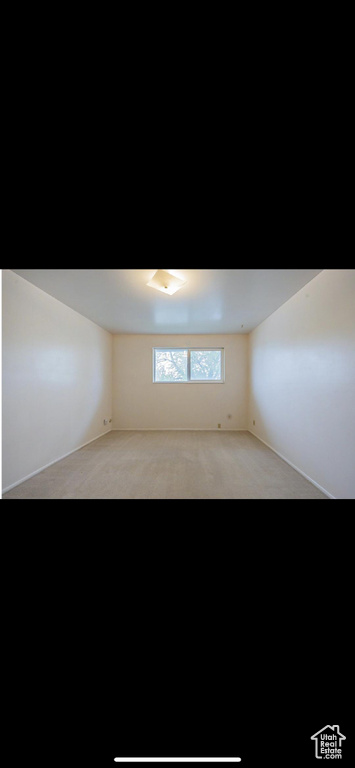 Spare room featuring light carpet