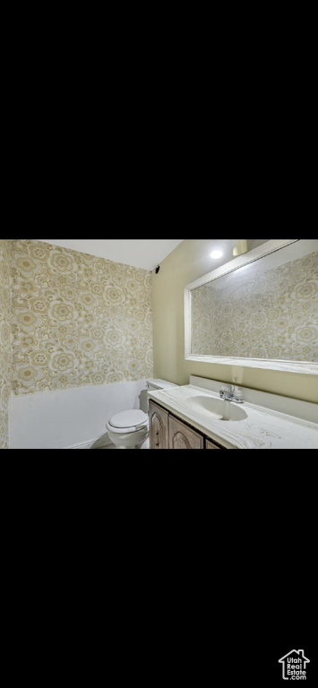 Half bath featuring vanity and toilet