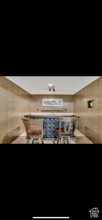 Detailed view of wallpapered walls and wood walls
