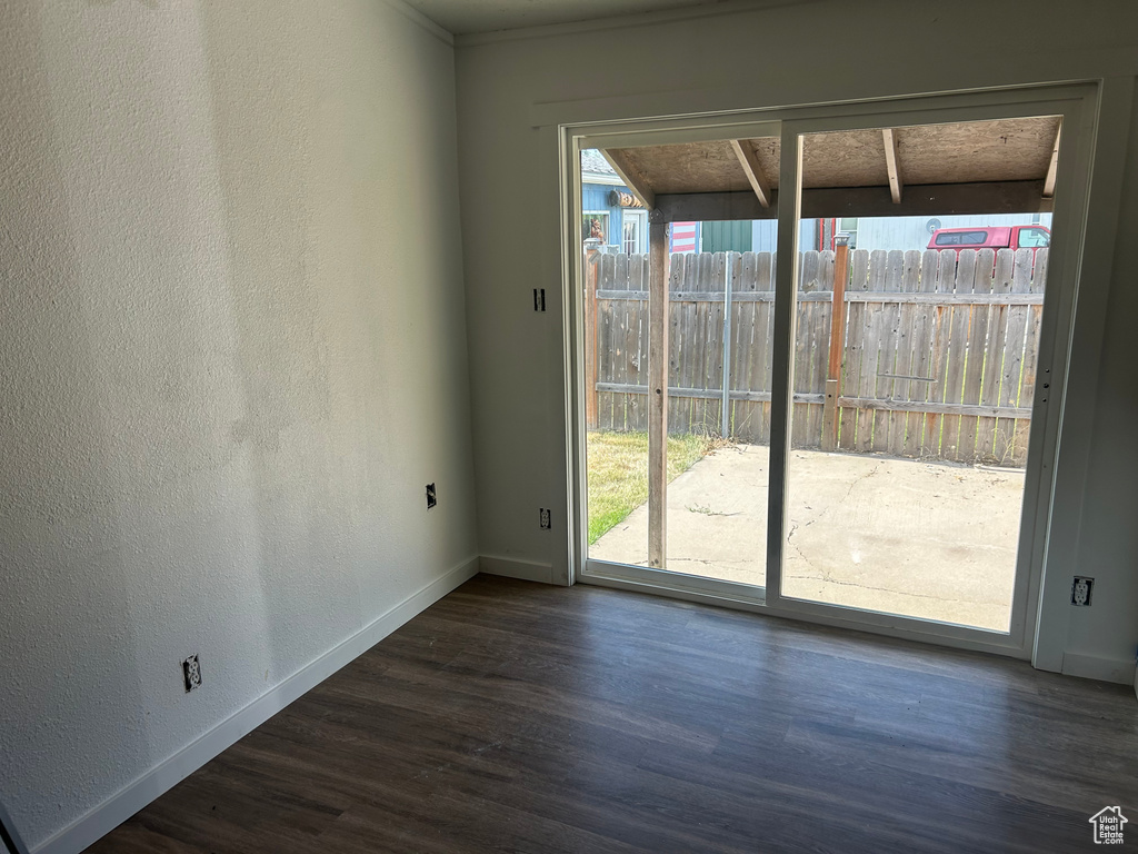 Unfurnished dining area with wood finished floors and baseboards