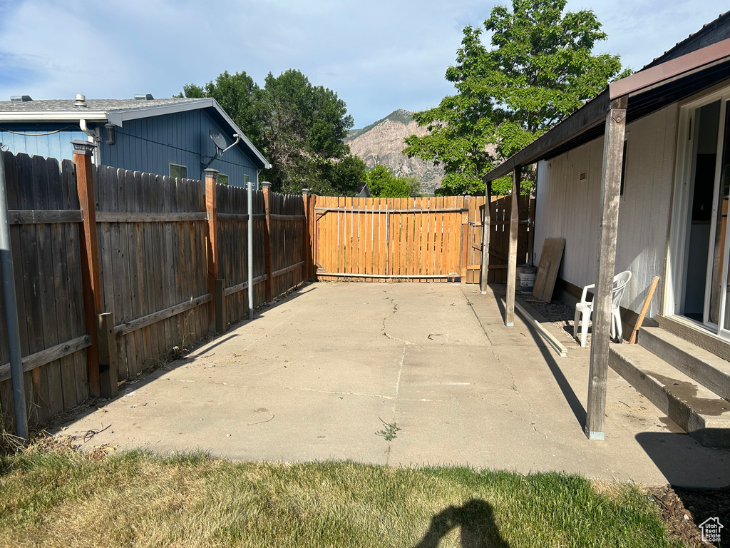 View of patio featuring entry steps and a mountain view