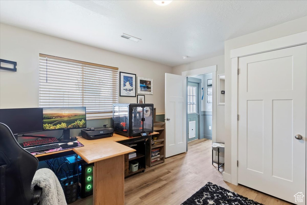 Office area with light wood-style floors