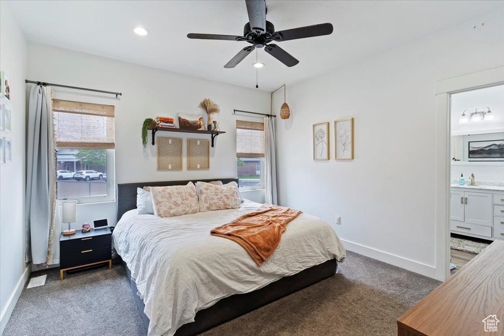 Carpeted bedroom with baseboards, ensuite bath, recessed lighting, and ceiling fan