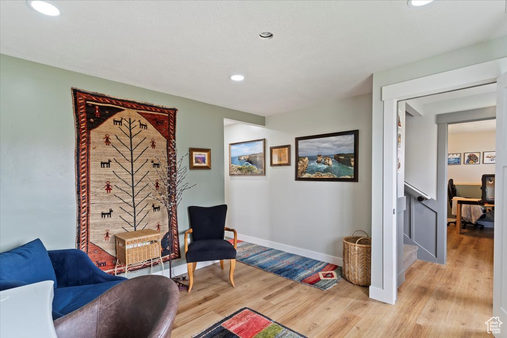 Living area featuring light wood-style floors, recessed lighting, and baseboards