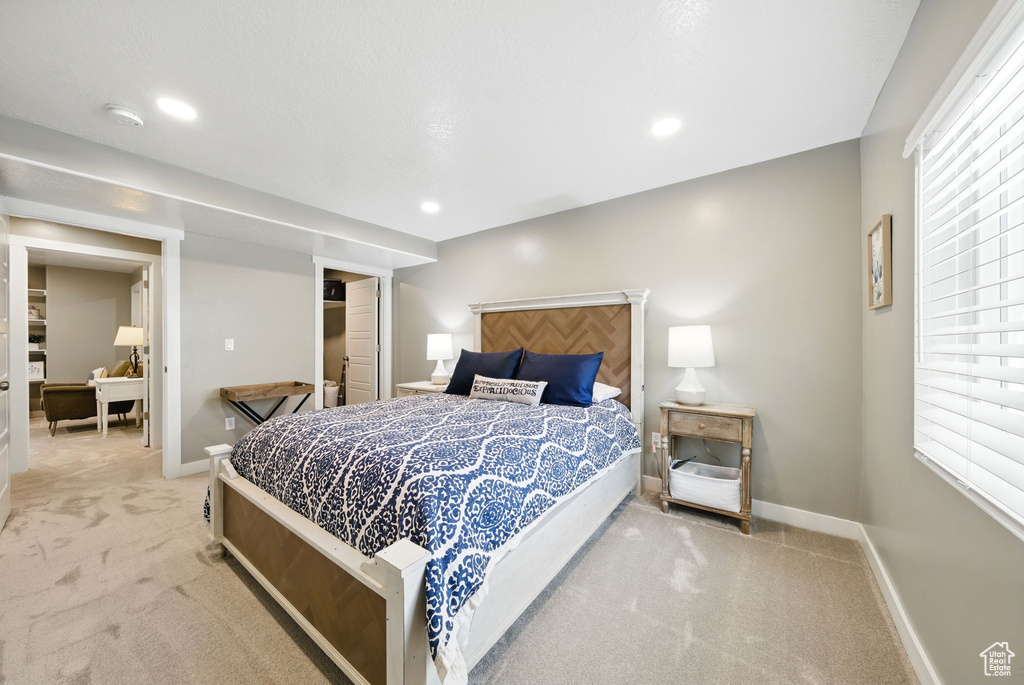 Bedroom with light colored carpet, baseboards, and recessed lighting