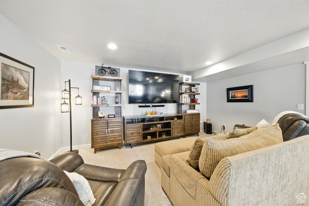 Carpeted living room featuring baseboards and recessed lighting