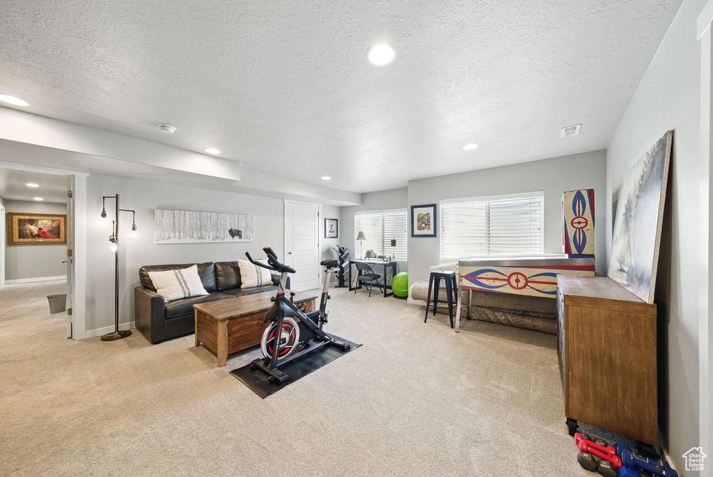 Workout room with carpet floors, a textured ceiling, recessed lighting, and baseboards