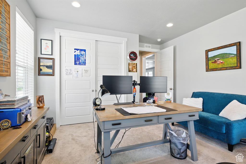 Office space featuring light colored carpet and recessed lighting