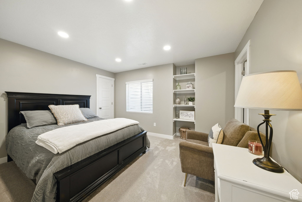 Bedroom with light carpet, recessed lighting, and baseboards