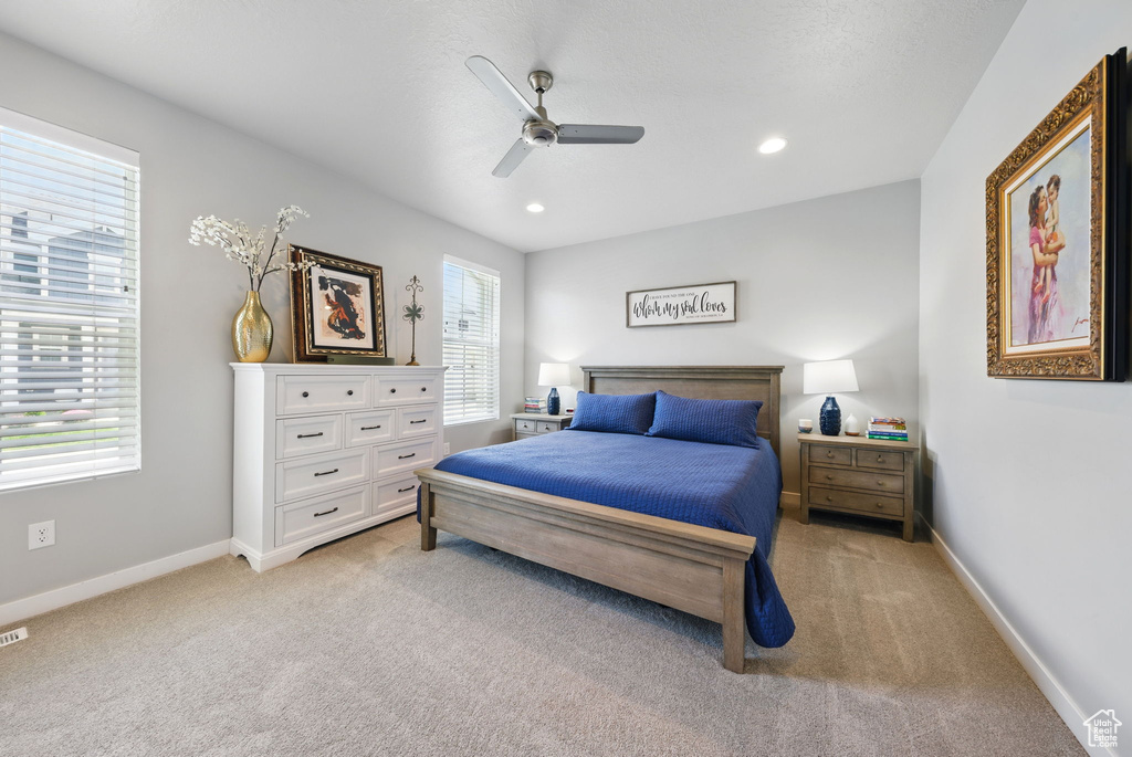 Bedroom with light colored carpet, baseboards, a ceiling fan, and recessed lighting