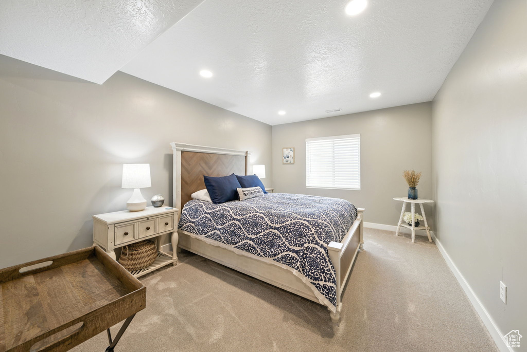 Bedroom featuring baseboards, light colored carpet, a textured ceiling, and recessed lighting
