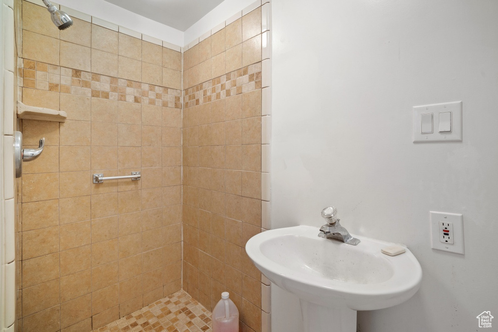 Full bathroom with a sink and tiled shower