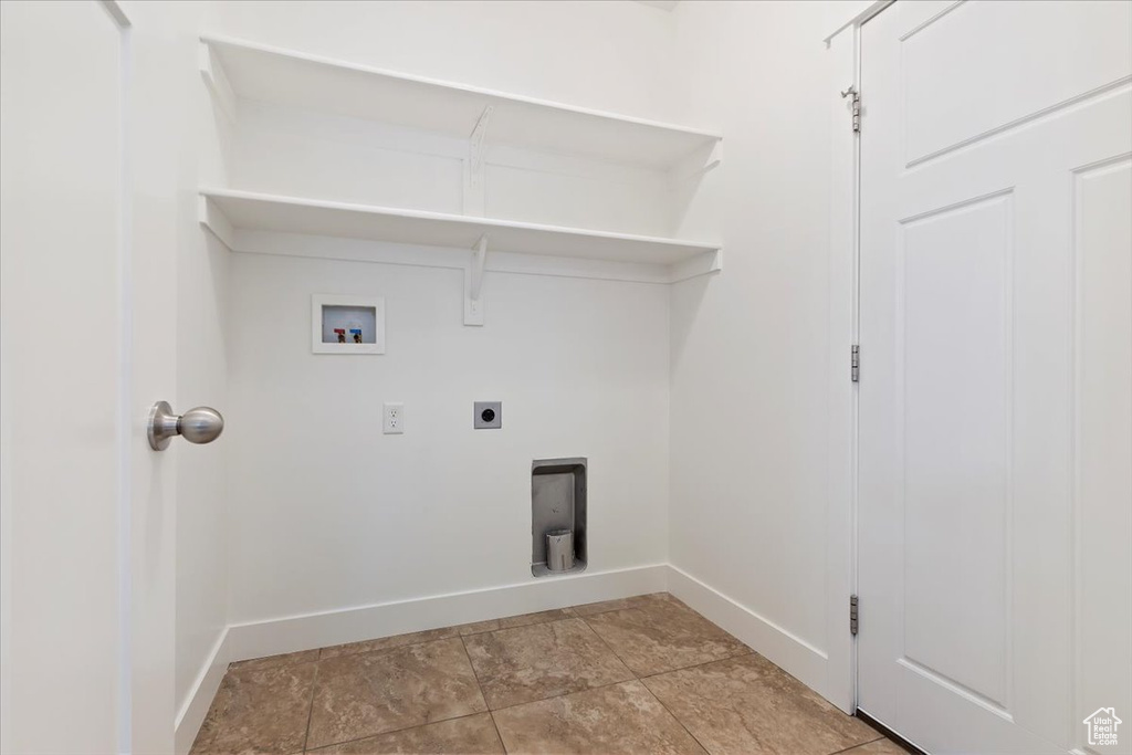 Laundry area featuring baseboards, hookup for an electric dryer, and washer hookup