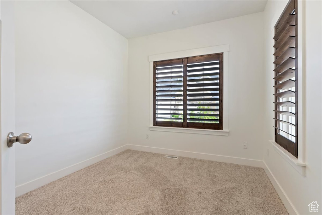 Carpeted empty room with baseboards
