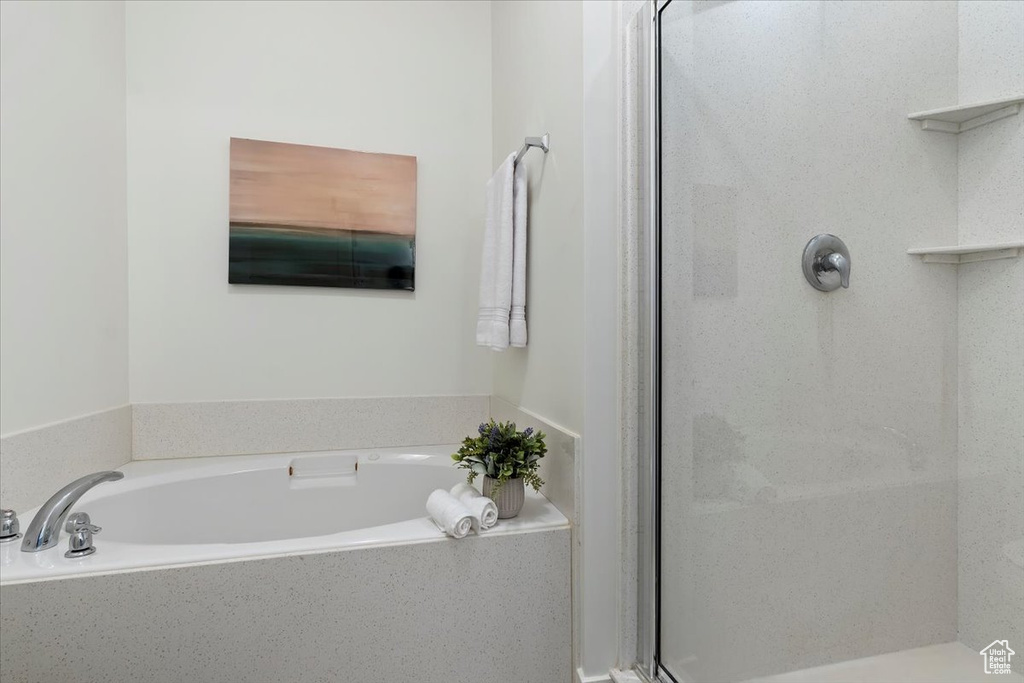 Full bathroom with a stall shower and a bath