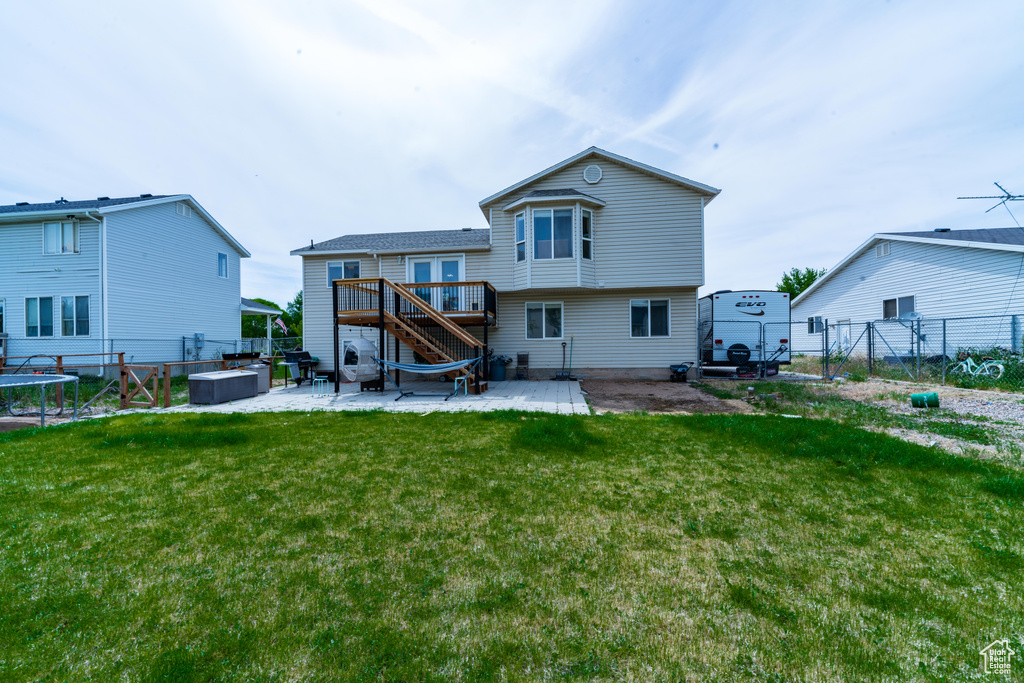 Back of house with a patio, stairs, and a deck