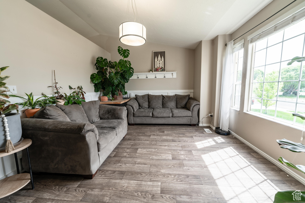 Living area featuring vaulted ceiling and wood finished floors