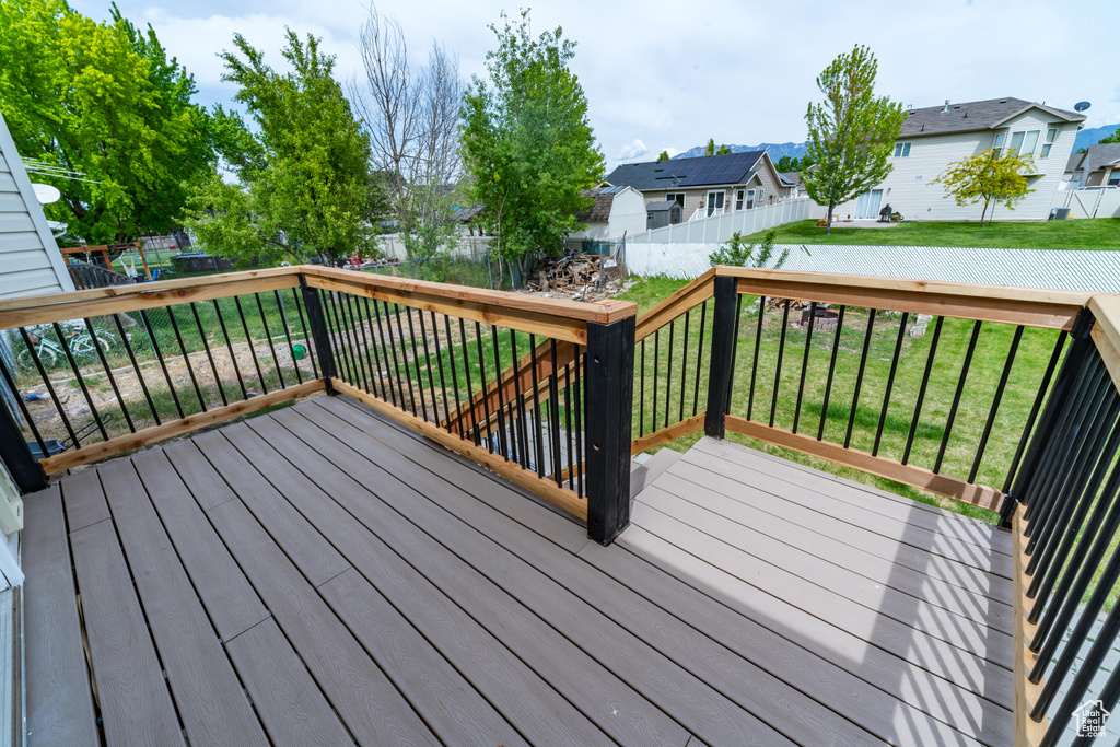 Wooden terrace featuring a residential view
