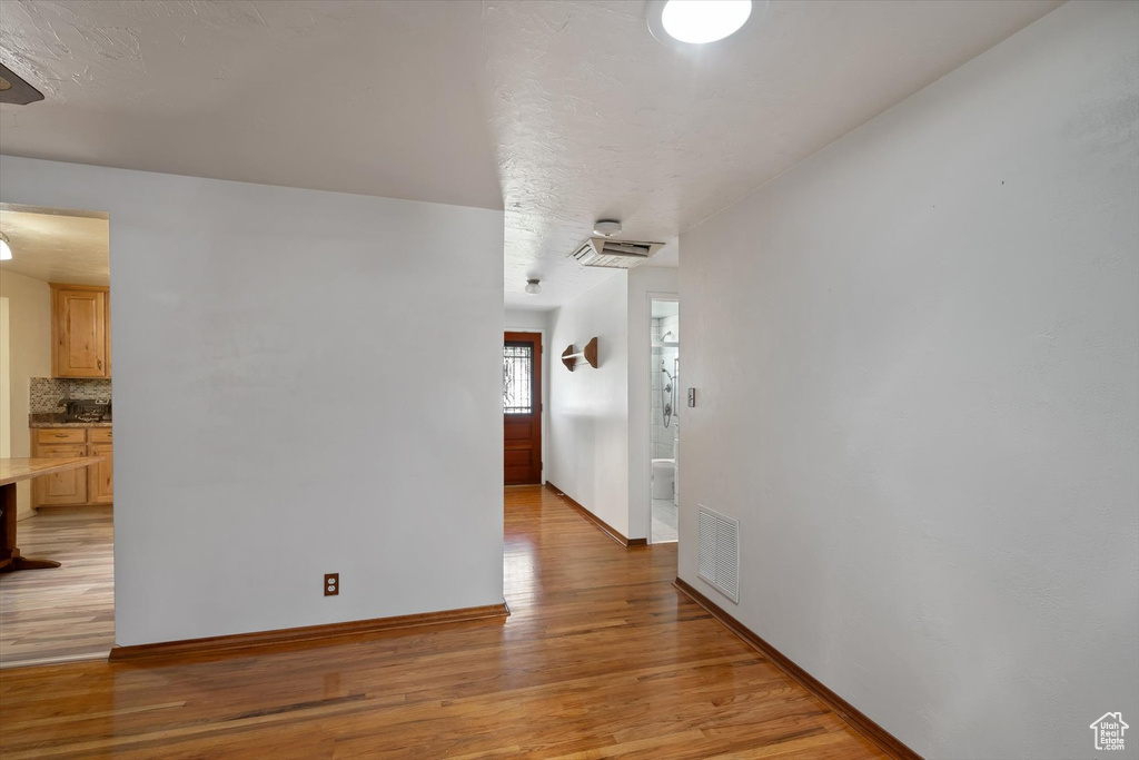 Hall featuring light wood finished floors and baseboards
