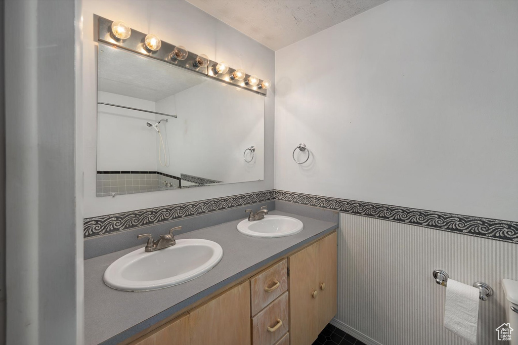 Full bath featuring double vanity