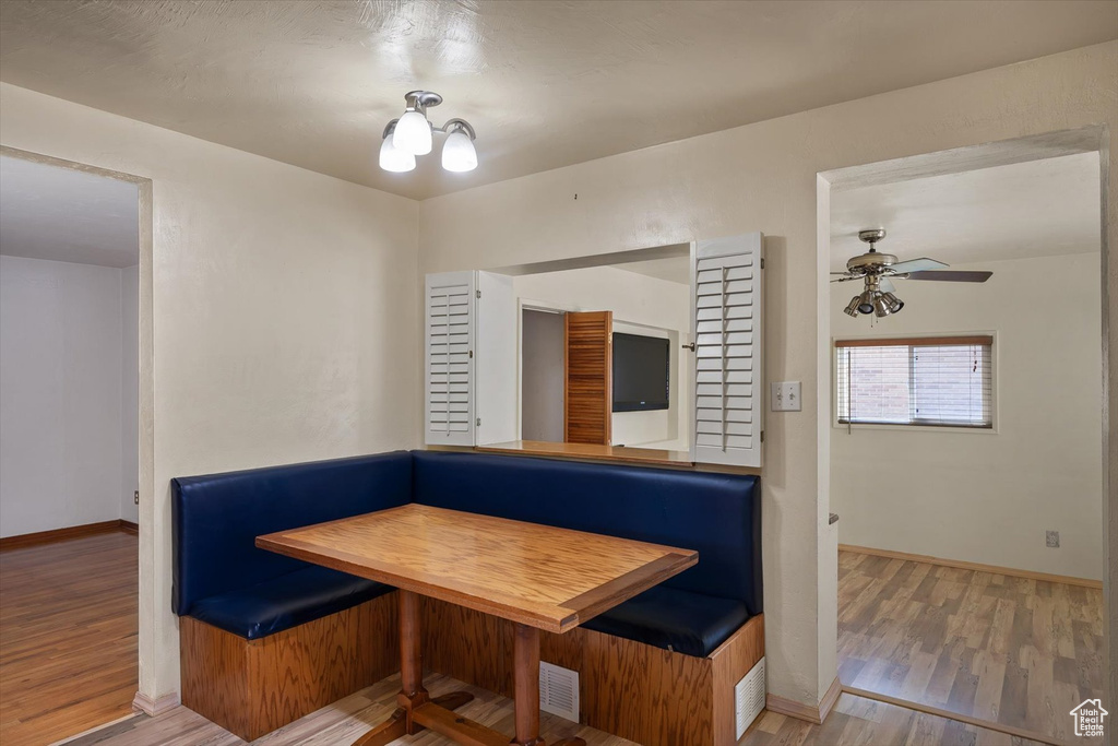 Unfurnished dining area with breakfast area, wood finished floors, and baseboards