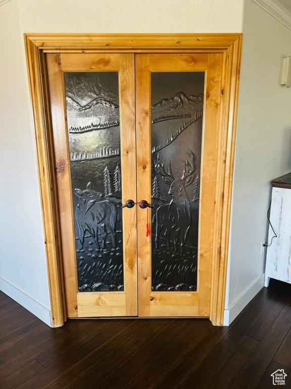Detailed view of french doors, baseboards, and wood finished floors