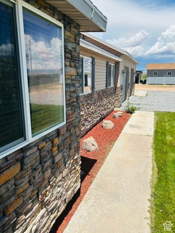 View of side of home with stone siding