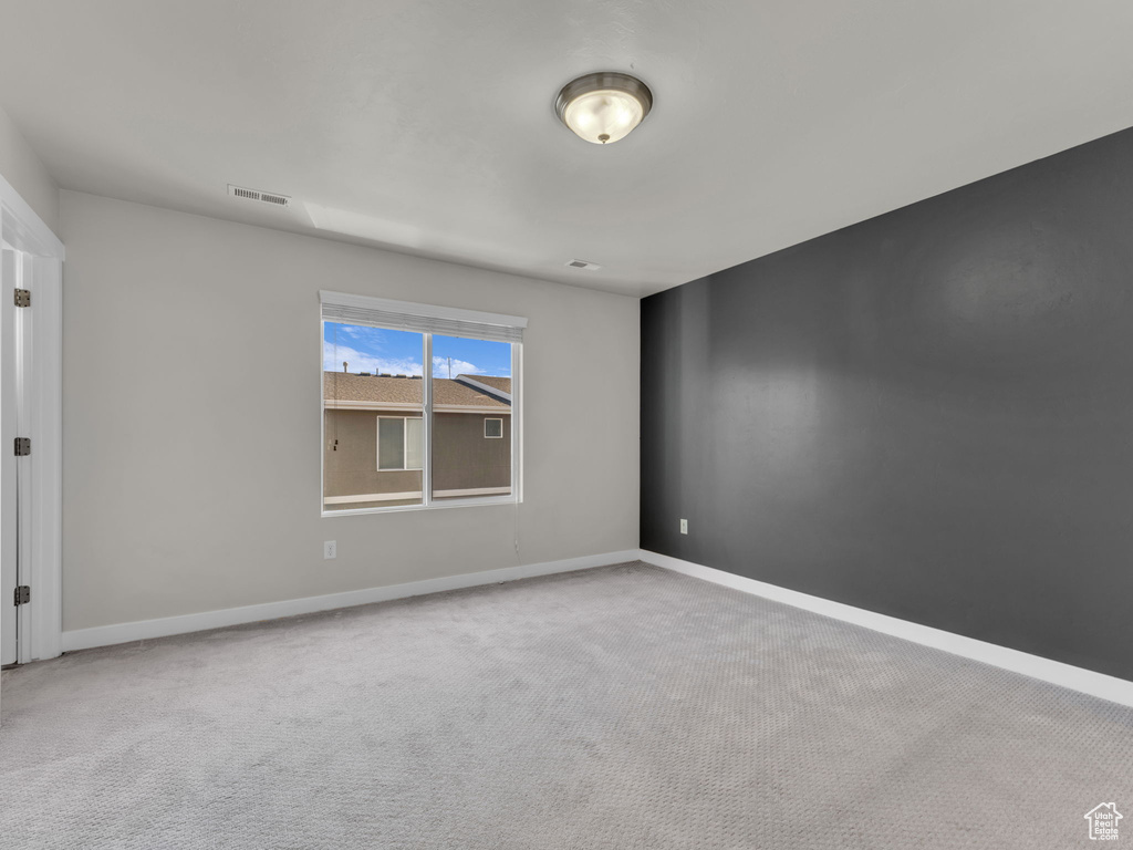 Unfurnished room featuring carpet and baseboards