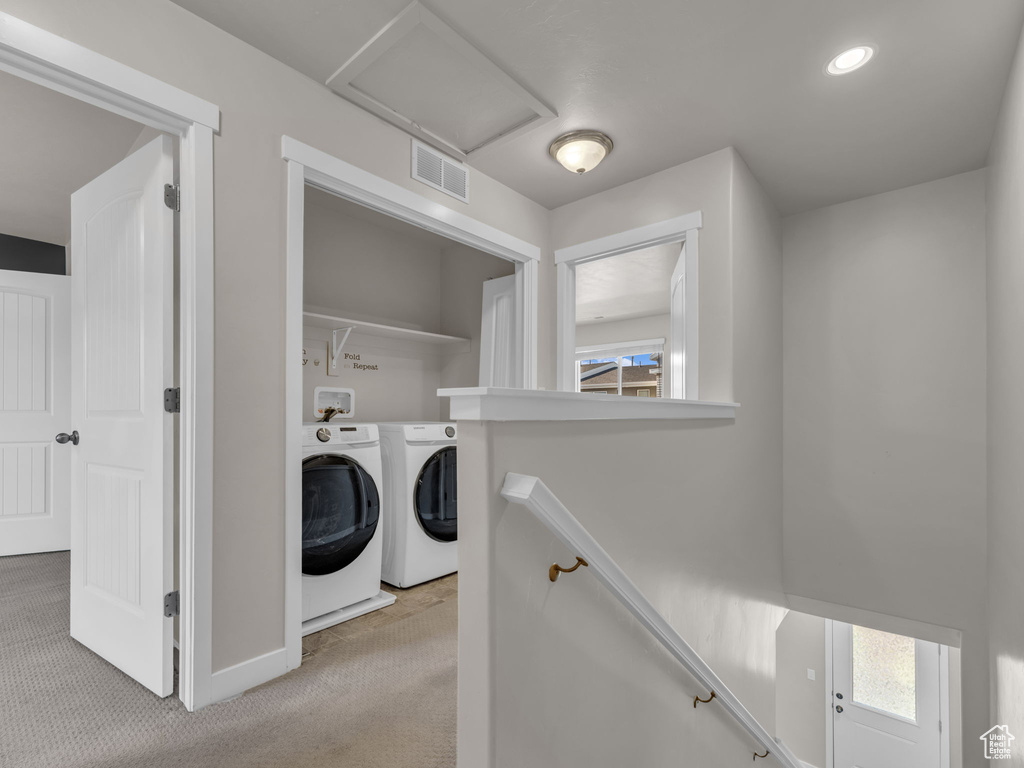 Laundry area featuring separate washer and dryer, light colored carpet, recessed lighting, and baseboards